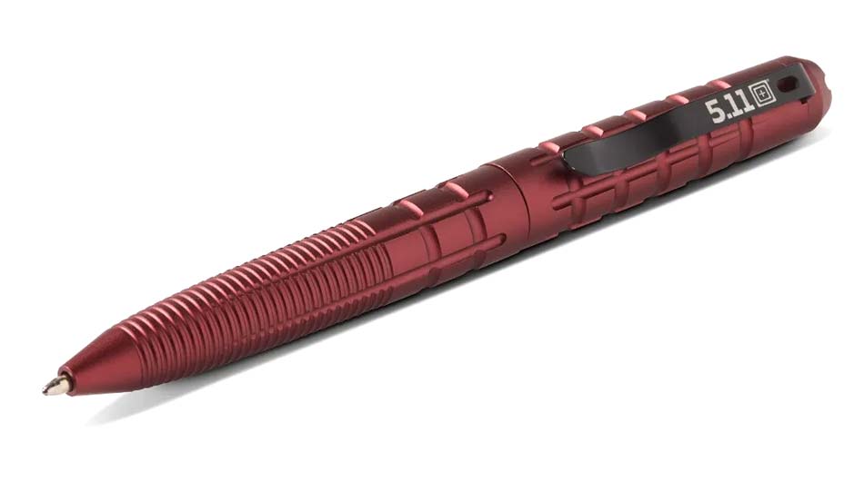 A close-up image of the 5.11 Tactical Kubaton Tactical Pen in its new Fired Brick color, showcased at the 2025 SHOT Show. This versatile tool functions as both a practical writing instrument and a discreet self-defense device, making it ideal for everyday carry. Made from lightweight, durable aluminum, the pen is designed to withstand daily wear and emergency use. Its ergonomic grip ensures comfort and control during writing or self-defense scenarios. The bold Fired Brick color adds a distinctive touch to the pen's sleek design, appealing to users seeking style and functionality. Equipped with a replaceable ink cartridge, the Kubaton Tactical Pen is always ready for action. Suitable for first responders, outdoor enthusiasts, and EDC enthusiasts, this tactical pen combines practicality, reliability, and individuality in a single tool.