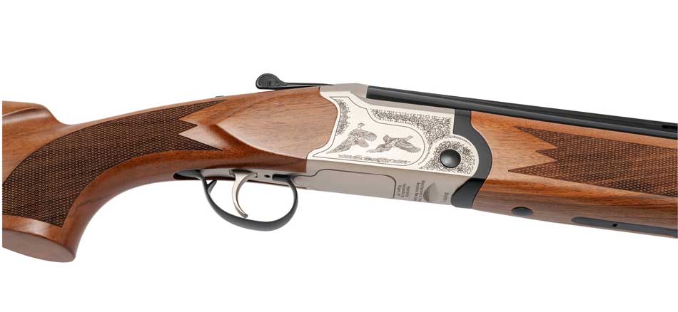 At the 2025 SHOT Show, I observed the ESCORT Optima Over/Under Shotgun displayed prominently under the exhibition lights. The model showcased featured a silver engraved receiver, highlighting intricate detailing that caught the eye. Its select Turkish walnut stock and forend exhibited a rich, polished finish, enhancing its elegant appearance. The 28-inch barrels were fitted with a 7x7mm ventilated rib, topped with a fiber optic front sight, indicating thoughtful design for improved targeting. The representative demonstrated the "Easy Adjust" action system, illustrating how it allows for smoother reloading by adjusting the force needed to open the action and eject spent shells. The overall craftsmanship and attention to detail were evident, making it a standout piece at the event.