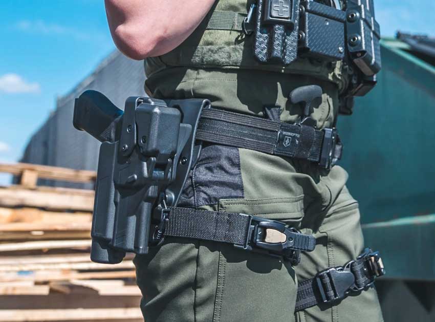 female police office in uniform carrying a Glock 19 in a Level III duty holster made by Alien Gear